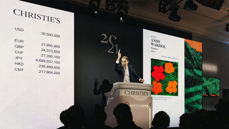 Christies Global Head of Private Sales Adrien Meyer sells the top lot of the evening Andy Warhol's Flowers